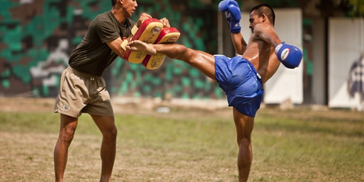 BAN CHAN KREM, Thailand -- During a cultural exchange, a Royal Thai Marine demonstrates his kicking ability which he utilizes for Thai boxing at the Ban Chan Krem training area here Feb. 15. Royal Thai Marines, Republic of Korea Marines and U.S. Marines with Combat Assault Battalion, 3rd Marine Division, III Marine Expeditionary Force, conducted trilateral training during Cobra Gold '12. Cobra Gold is a recurring multinational and multiservice exercise hosted by the Royal Kingdom of Thailand designed to advance regional security by exercising a multinational force from nations sharing common goals and security commitments in the Asia-Pacific region. (U.S. Marine Corps photo by Sgt. Brandon L. Saunders/released)