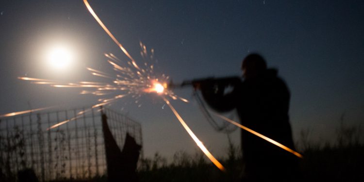 Daily life of Ukrainian soldiers from 54th brygade, 1st batalion, 1st company, based and fighting in the Luganskoye village aera. Soldiers are based in couple of abandoned houses and in tranches outside the village. on picture: Ukrainian soldier fires back after recognising DNR (Donieck National Republic)  fighter trying to overrun his position. Behind trenches is the frontline 13th of July 2016, photo by Wojciech Grzedzinski